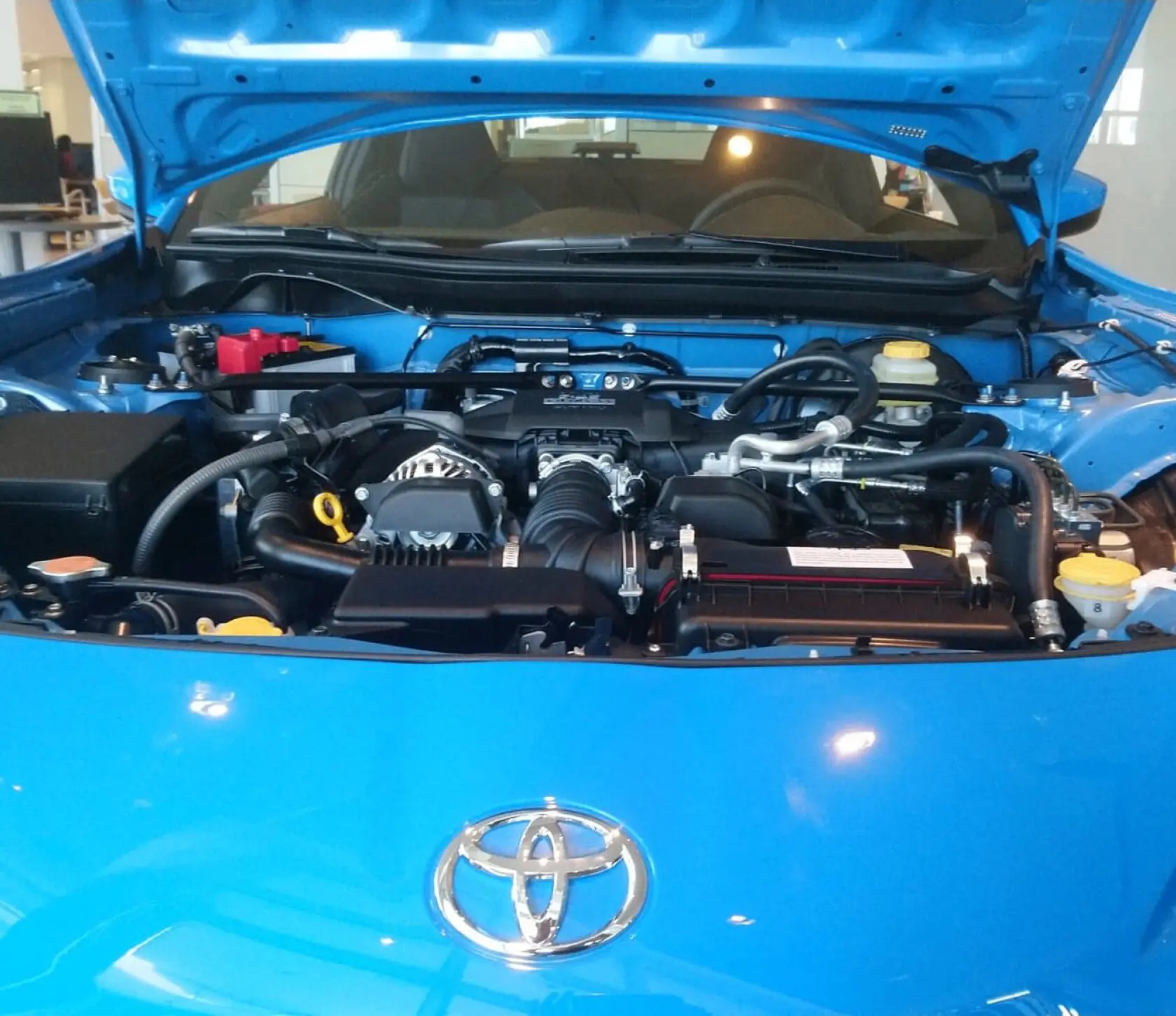Blue car engine with open hood.